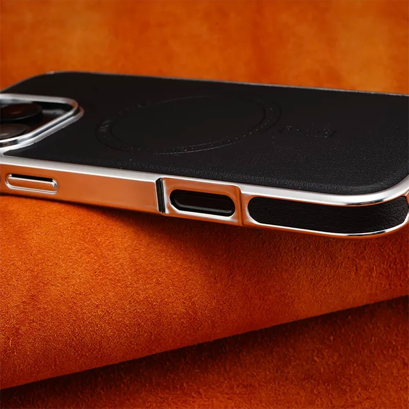Close-up of luxurious iPhone case featuring wireless charging capability on orange background.